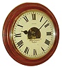 Eureka Clock Co., London, gallery clock, turned mahogany front mounted to a dovetailed mahogany case with battery compartment at lower right, brass bezel, Roman numeral white painted metal dial, black painted steel hands, dial center with cutout revealing the Eureka electric movement with large balance wheel, serial #5144, c1910