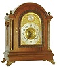 Tiffany & Co. Makers, New York, large mahogany bracket clock with quarter striking, mahogany case with cast brass scroll feet, brass Corinthian columns flanking the arched, cast brass door with acanthus leaf decoration and thick beveled glass, each side with fabric lined brass fret and heavy cast carrying handles, the four corners of the top with spherical brass finials, case back with mahogany door and fabric lined screen, thick brass composite dial with gilt spandrels, Arabic numeral silvered dial marked "Tiffany & Co. Makers", dial arch with gilt putti flanking silvered Strike/ Silent indicator, pierced steel hands, very substantial brass movement with Brocot escapement, back plate  marked "Tiffany & Co. Makers Patented Nov. 7th 1882" and with the number 716, full Westminster chimes and hour striking on 5 gongs, original pendulum and key, c1890