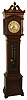 Seth Thomas Clock Co., Thomaston, Conn., "Hall Clock No. 23" tall clock, 8 days, time and bell strike, weight driven movement with deadbeat escapement in an oak case with turned and reeded columns with metal Corinthian caps, shell carving above dial and silvered round metal dial, c1906