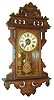 E. N. Welch Mfg. Co., Forestville, Conn., 8 day, time, strike and alarm hanging gingerbread clock. c.1885  Label states this clock was manufactured exclusively for: "Metropolitan Manufacturing Co.".