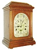 Lenzkirch, Germany, 3 train quarter striking bracket clock, oak case of architectural design, the door with thick beveled glass, back door pierced and with fabric lining, silvered dial with Roman numeral chapter ring, the corners and center decorated with calligraphic style birds and flourishes, blued steel hands, brass movement with Westminster chime and hour striking on five gongs, pull repeat activated by pulling cord at right side of case