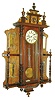 Gustav Becker, Silesia, Germany, "Vienna Regulator" wall clock, 8 days, time and gong strike, spring driven movement in a walnut case with turned half columns, mirrored side panels and top crest with Jenny Lind head and turned ornamentation.  The dial is multicolor enamel, c1880