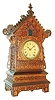 Jig saw or Sorrento work cuckoo clock of architectural form, ash case with walnut fretwork, brass bezel, Roman numeral paper dial, blued steel spade hands, 8 day time and strike Seth Thomas movement, now activating a music box at the hour and half hour, c1885