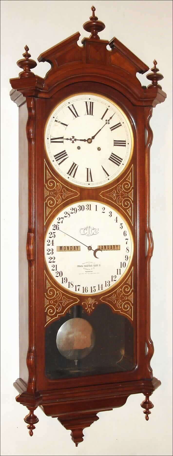 Ithaca Calendar Clock Co., Ithaca, New York "No. 2 Bank" double dial calendar regulator wall clock, 8 day, time only, two weight driven movement in a walnut case with engraved mask around paper over zinc dials, c1880 — Antique Clocks Price Guide