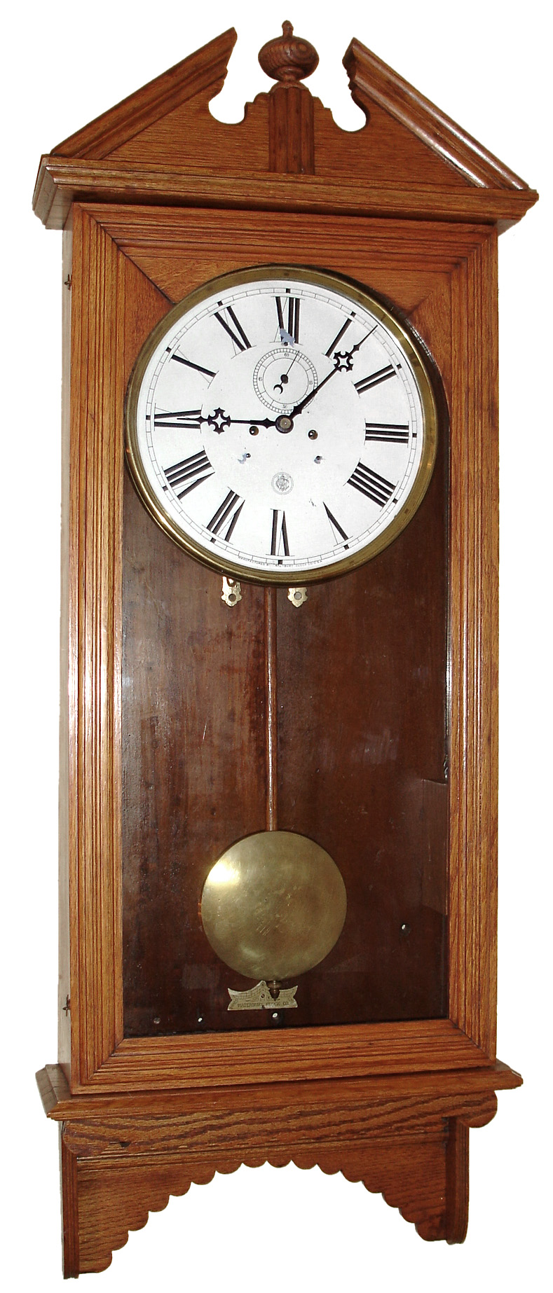 Waterbury Clock Co., Waterbury, Conn., "Regulator No. 18" wall clock, 8 day, time only, two weight driven movement in an oak case with painted metal dial, c1893 — Antique Clocks Price Guide