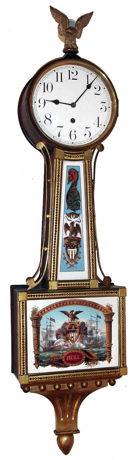 Waterbury Clock Co., Waterbury, Conn., "Willard No. 3" banjo wall clock, 8 day, time only, weight driven movement in gilded mahogany case with presentation base, reverse painted throat and lower tablets and white enamel dial, c1906 — Antique Clocks Price Guide