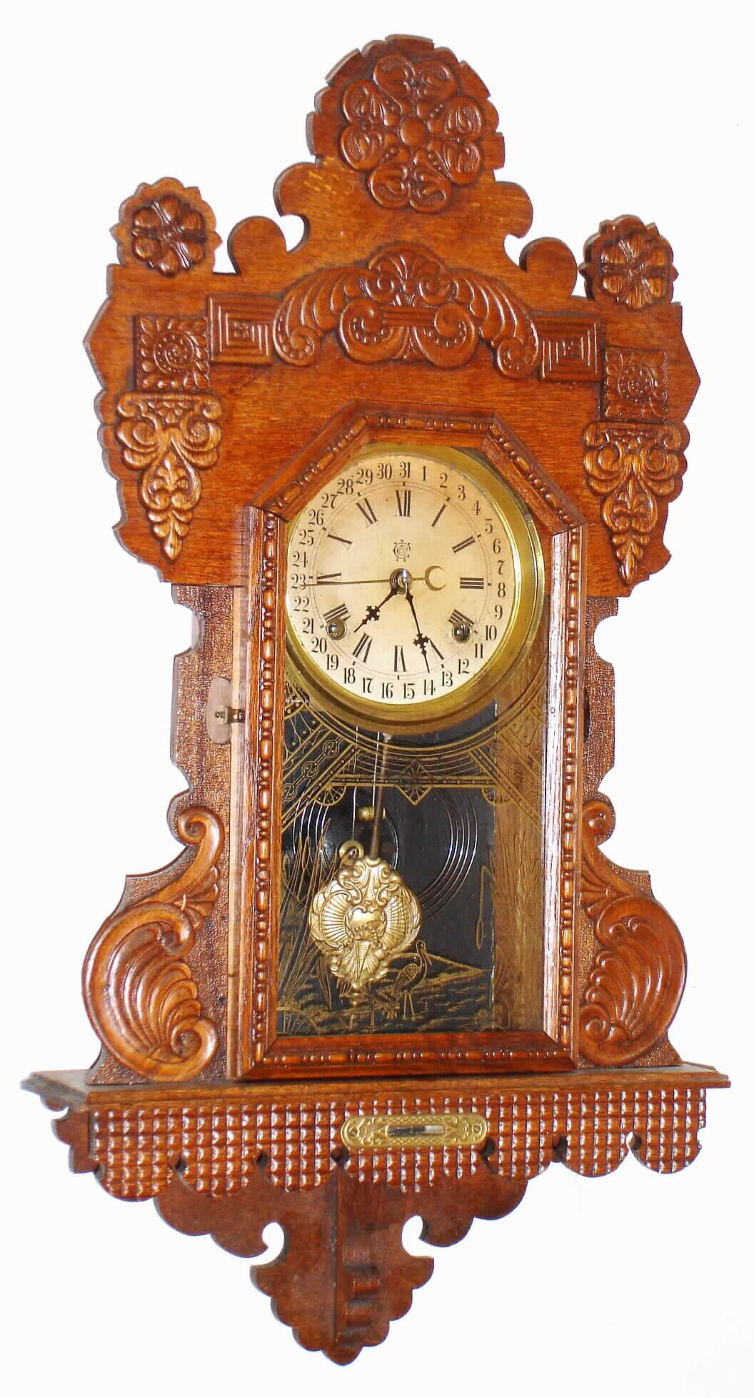 Waterbury Clock Co., Waterbury, Conn., oak hanging gingerbread, 8 day, time and strike calendar clock, c1900 — Antique Clocks Price Guide