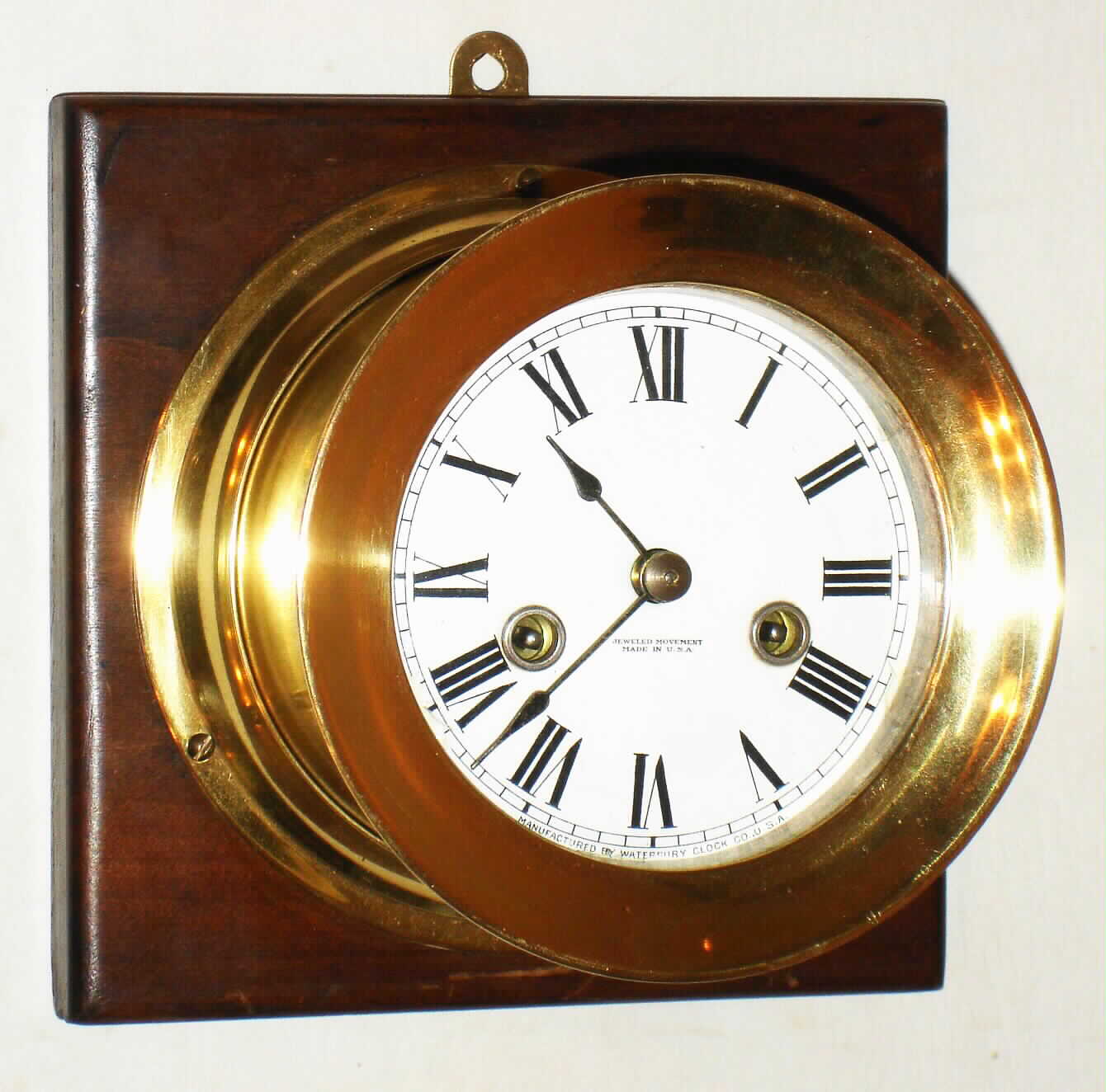 Waterbury Clock Co., Waterbury, Conn., "Ship's Bell No. 1" brass 8 day striking clock on wood, c1915 — Antique Clocks Price Guide
