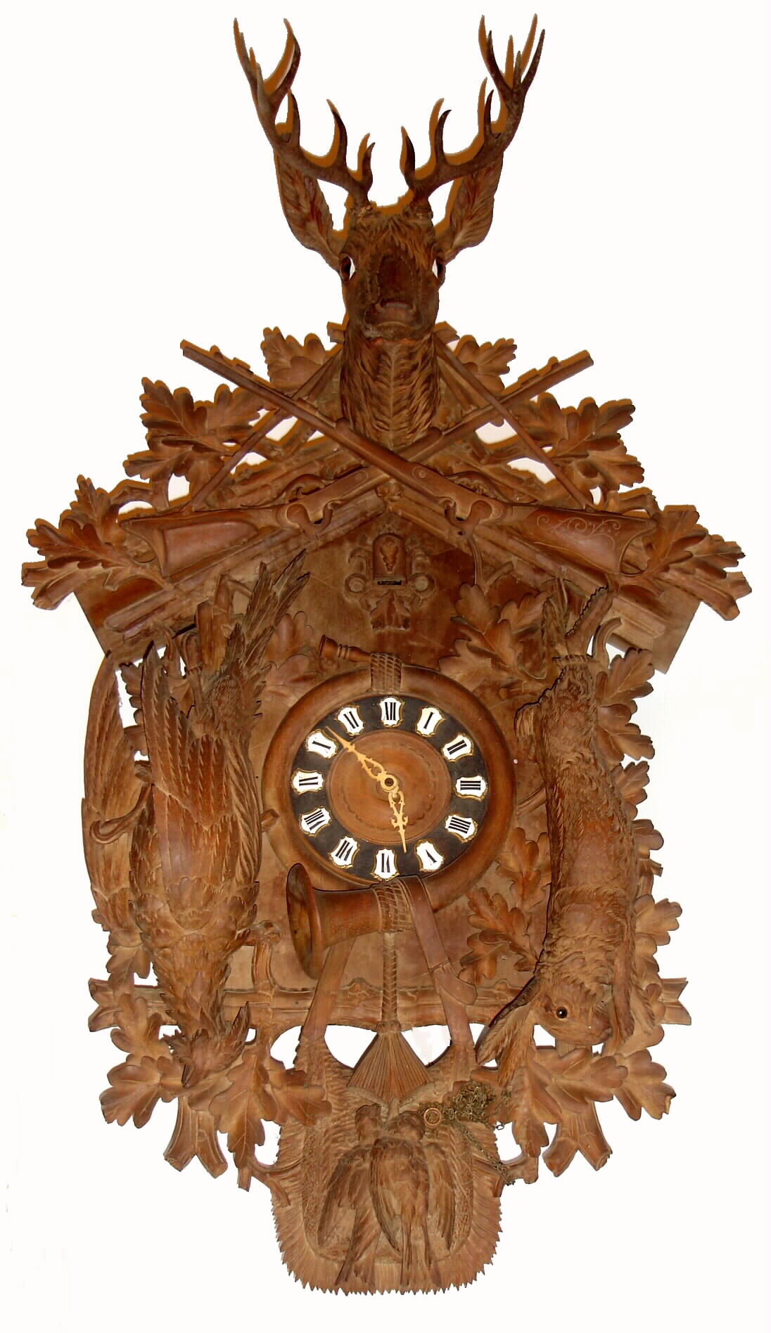 German, large Black Forest carved cuckoo clock, hunter motif with cross rifles and deer head at top, and with life size pheasant and rabbit to the sides, 1-day time and strike, 2-wt, c1910. — Antique Clocks Price Guide