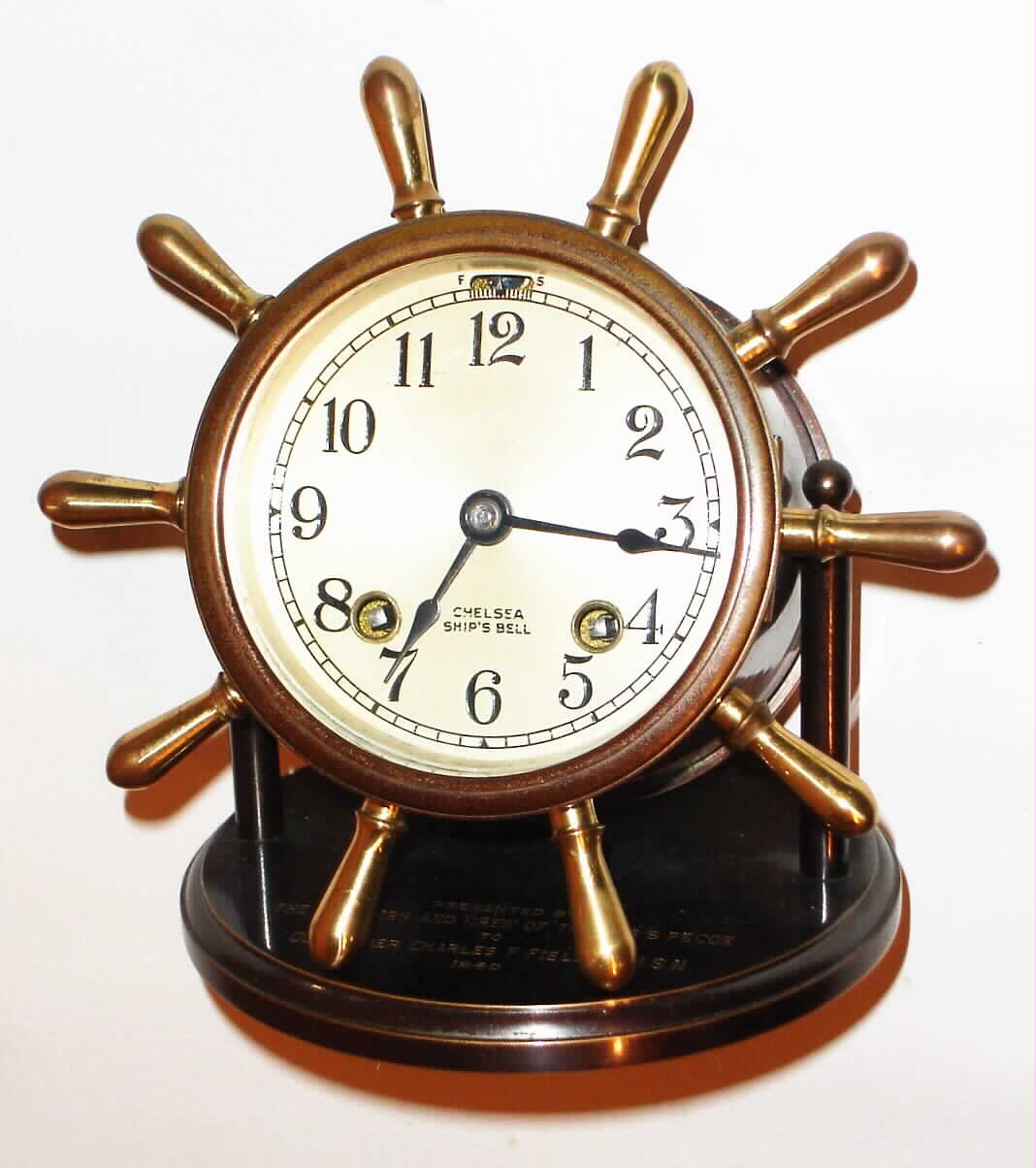 Chelsea Clock Co., Boston, Mass., "Clinton", 8 day, time and strike, ship's bell mantel or desk clock, s#269055 stamped on movement. Engraved on the base is the following: "Presented by the Officers and Crew of the USS Pecos to Commander Charles F. Fielding, U.S.N. 1940", c1939 — Antique Clocks Price Guide