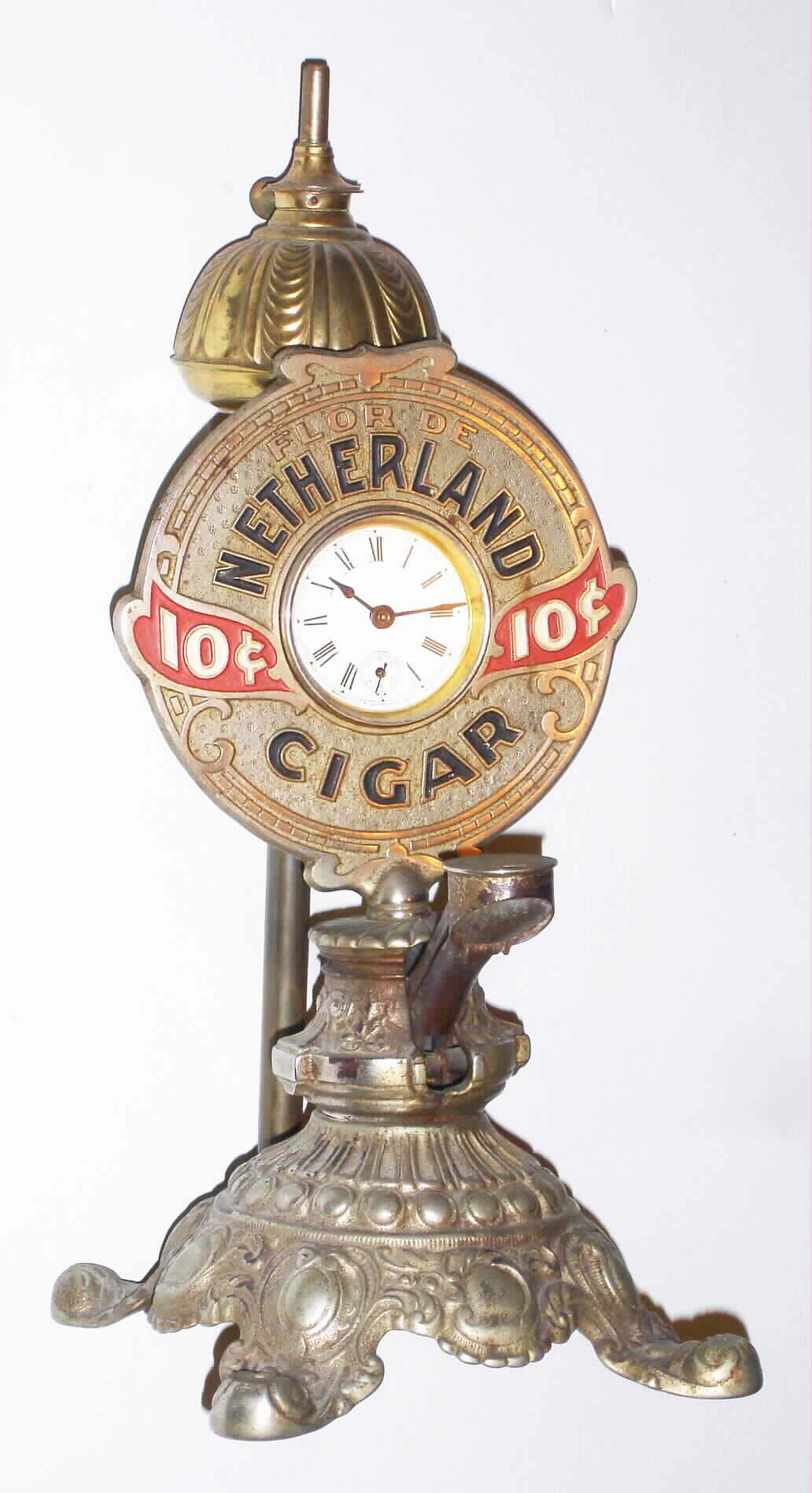 Waterbury Clock Co., Waterbury, Conn., advertising 30 hour cast iron time piece with "Netherland Cigar" cutter and lamp, c1910 — Antique Clocks Price Guide