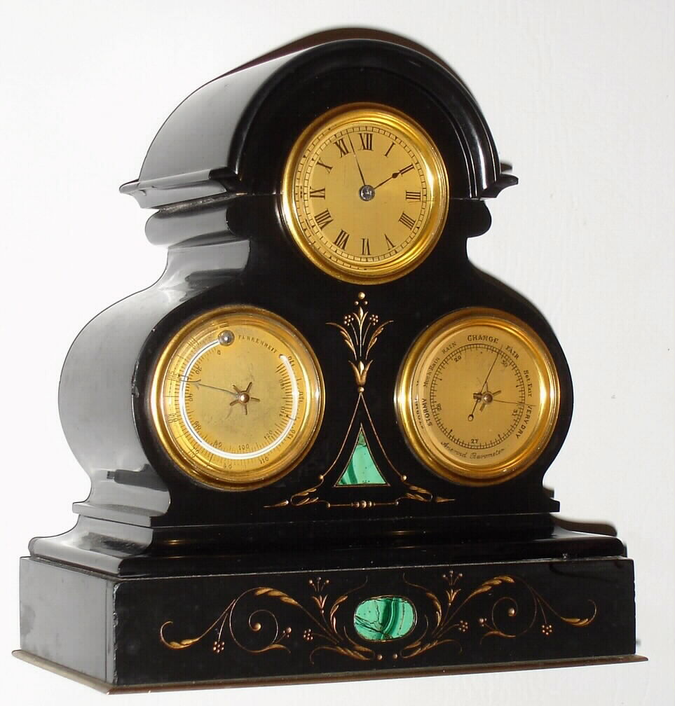 French miniature black slate mantel clock, with time, thermometer and barometer, spring driven eight day movement with jeweled lever platform escapement, matte gilt brass dials, all with gilt brass bezels and beveled glasses, Roman numeral time with painted figures and blued steel hands, thermometer and barometer also with painted figures, the polished black slate case with incised gilt ornament and faux malachite panels, base finished with a thin gilt brass molding, c1870 — Antique Clocks Price Guide