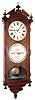 Ithaca Calendar Clock Co., Ithaca, New York "No. 2 Bank" double dial calendar regulator wall clock, 8 day, time only, two weight driven movement in a walnut case with engraved mask around paper over zinc dials, c1880