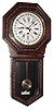 Waterbury Clock Co., Waterbury, Conn., "10 Inch Heron" wall clock, 8 day, time and calendar, spring driven movement in an embossed oak case with papered dial, c1905
