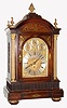 English, John Smith and Son, 85 Strand, London, large 3-fusee, 8-bell, 2-tune, quarter chiming bracket clock, the rosewood veneer case with brass inlay, the door flanked by gilt and reeded brass columns, the side frets of cast brass in the Georgian style, and the arched dial with applied brass spandrels and with 3 subsidiary dials for F/S, Chime/Silent, and 8-bell or Westminster tune. Overall very good original condition, c1890