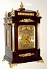 English, first class maker, for J. E. Caldwell, Philadelphia, a triple fusee, 8-Bell and Westminster on gongs, bracket clock, chiming the quarters on your choice of bells or gongs, and counting the hours on a large flat wire cathedral gong, the cushion top dial with applied gilt Roman numerals, and with subsidiary dials for F/S, Chime-Silent, and choice of tune; case with profuse ormolu trim, c1890.