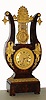 French lyre form mantel clock, spring powered eight day time and strike movement, visible gilt brass gridiron pendulum with acanthus and swan decoration suspended above the movement, Roman numeral dial with painted figures, the case veneered in good quality figured mahogany, decorated with classically themed gilt bronze mounts, including anthemion, scrolls, overflowing cornucopia, laurel, parsley and waterleaf, c1825