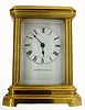 New Haven Clock Co., New Haven, Ct., carriage clock in polished brass case, beveled glass sides and top, spring powered eight day time only movement, with lever escapement, movement train plate with frosted gilt finish, back plate with gilt bright polished and damascene decoration, ratchet wheel cock with decorative engraving, white enamel dial with Roman numerals and signed New Haven Clock Co., blued steel hands, c1885