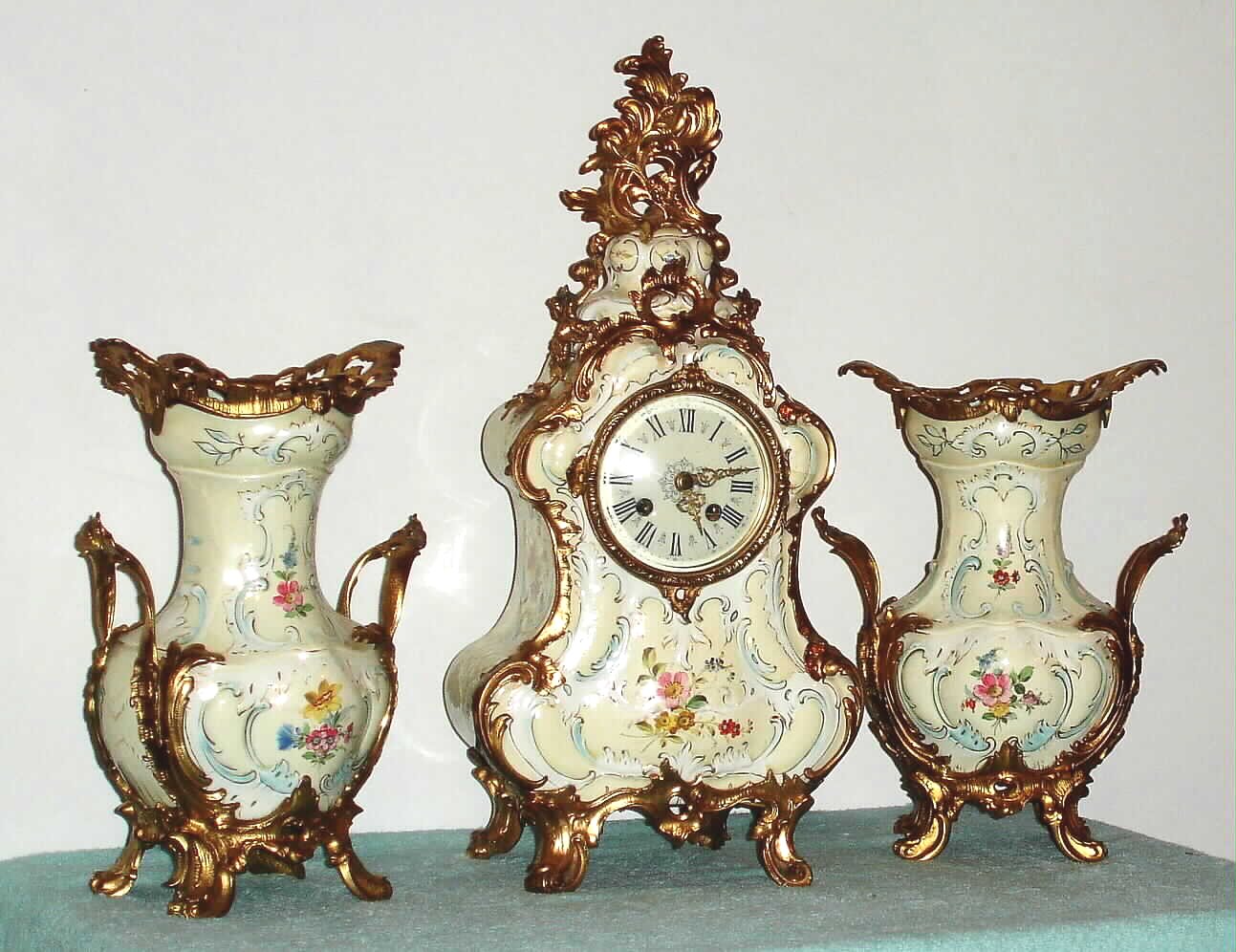 German, Lenzkirch, 3-piece mantel set of porcelain with ormolu adornments, and with quality round movement with porcelain dial and fancy brass hands, the case and side pieces with floral trim, c1875 — Antique Clocks Price Guide