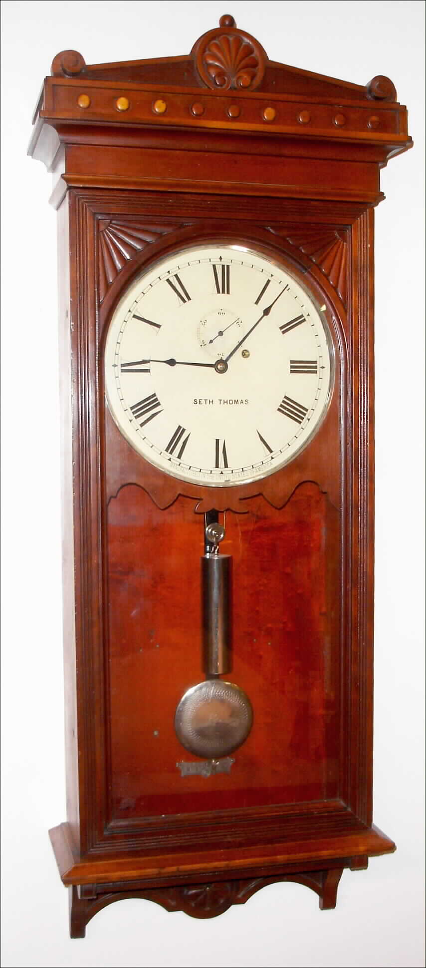 Seth Thomas Clock Co., Thomaston, Conn., "Regulator No. 30" wall clock, 8 day, time only, weight driven movement with nickel plated pulley, weight, pendulum bob, indicator and hinges, in cherry case with painted metal dial, c1880 — Antique Clocks Price Guide