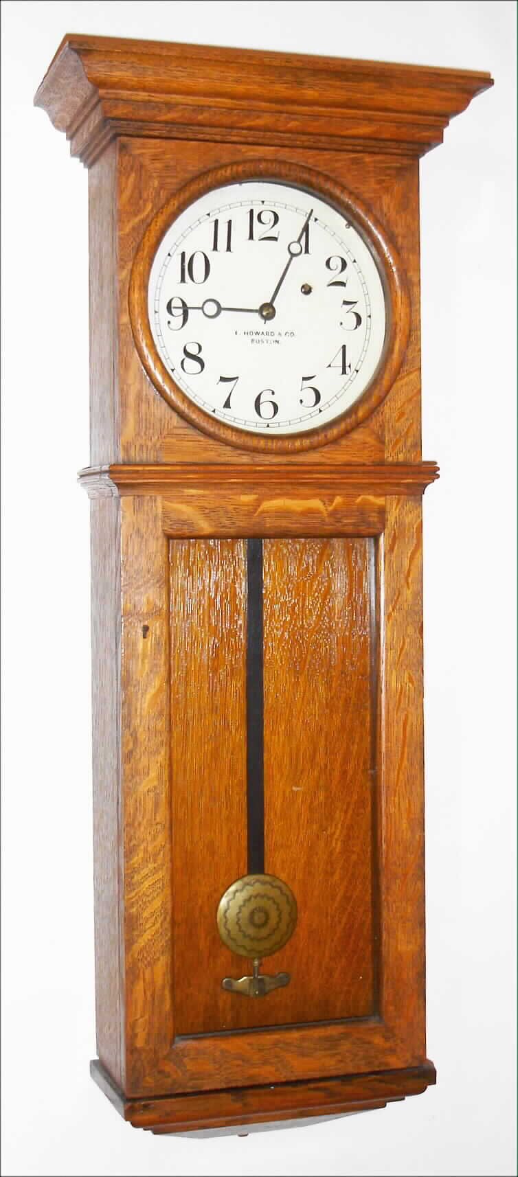 E. Howard and Co., Boston, Mass., for L.A. Fewkes, Boston, "Special Order" wall clock, 8 day, time only, weight driven movement stamped "E. Howard and Co. Boston" and "L.A. FEWKES BOSTON Mass.SS. 1900" with #70 stamped weight in an oak case with painted iron dial signed "E. HOWARD and CO. BOSTON" and standard Howard type brass damascened pendulum bob, c1900 — Antique Clocks Price Guide