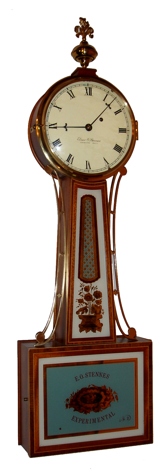 Elmer O. Stennes, Weymouth, Mass., "Experimental Banjo No. 2" wall clock, 8 day, time only, weight driven movement in a cross banded inlaid mahogany case with reverse painted throat and lower tablets and a painted metal dial signed "Elmer O. Stennes WEYMOUTH Mass.SS.", s#30, dated 1972 — Antique Clocks Price Guide
