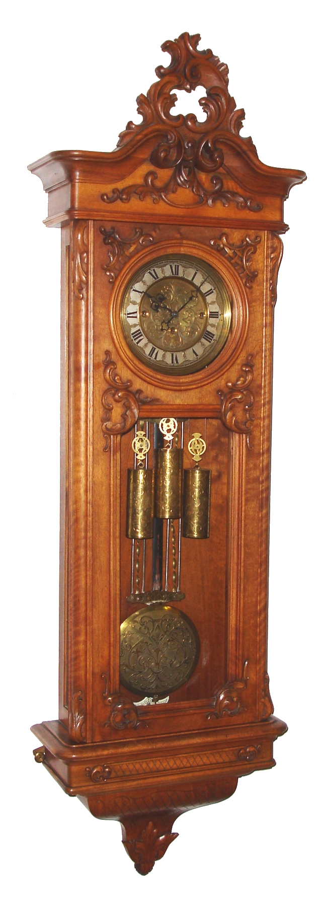 Erste Karlsteiner Uhren Industrie, Karlstein, Austria, "Vienna Regulator" of second Baroque period, 8 day, time and Grande Sonnerie strike, three weight driven movement in a walnut case with applied carvings and engraving and finely cutout and engraved brass dial surround and center mounted on silvered chapter ring, brass weights and pendulum also engraved, c1885 — Antique Clocks Price Guide