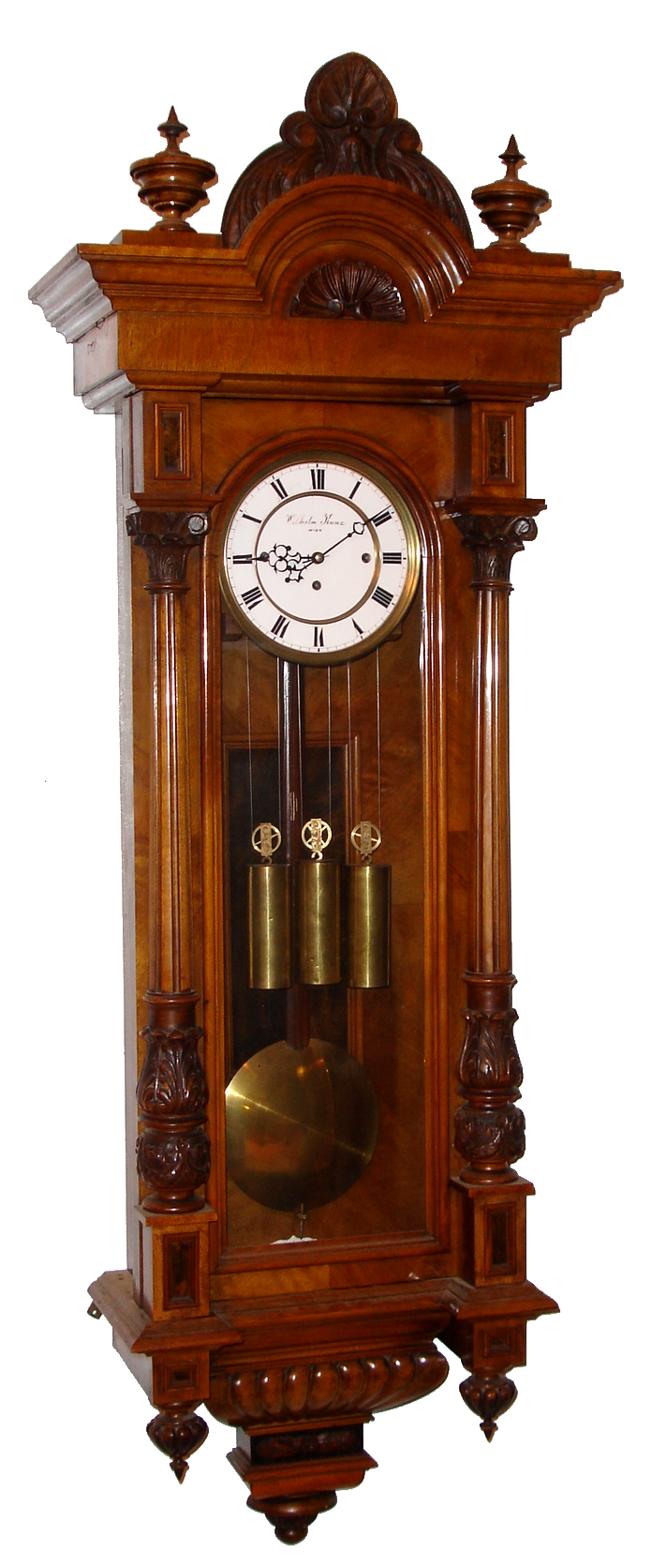 Wilhelm Kunz, Wien, Austria "Vienna Regulator in Altdeutsch Style" wall clock, 8 day, time and Grande Sonnerie strike, three weight driven movement in a walnut case flanked by fluted fully turned columns with elaborately carved capitals and bases and two part white enamel dial, c1880 — Antique Clocks Price Guide