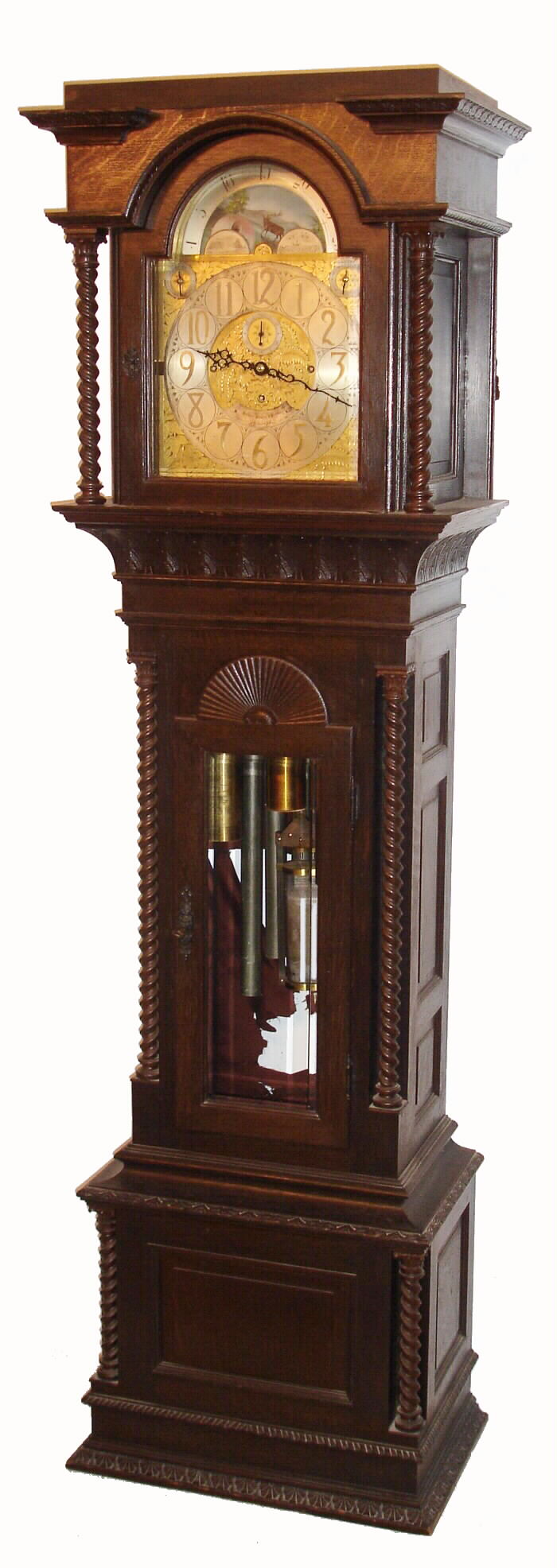 Walter H. Durfee, Providence, Rhode Island, for Bailey, Banks and Biddle, Philadelphia, Penn. on dial, 9 tube hall clock, 8 day, time, strike and 1/4 chime three weight driven movement playing Westminster or Whittington tune on tubes signed by Walter Durfee with patent date 1887 and with single jar mercury pendulum.  The silvered brass dial has moon phase with elk scene, strike / silent and tune selector discs.  The case is oak with a dark walnut finish and has carved cornice moldings, 11 raised panels, barley twist columns, of which four are flanking the trunk and two are flanking hood, sunburst carving above trunk door and beveled glass in hood and trunk doors.  There are exceptional lion's head escutcheons on both hood and trunk doors, c1895 — Antique Clocks Price Guide