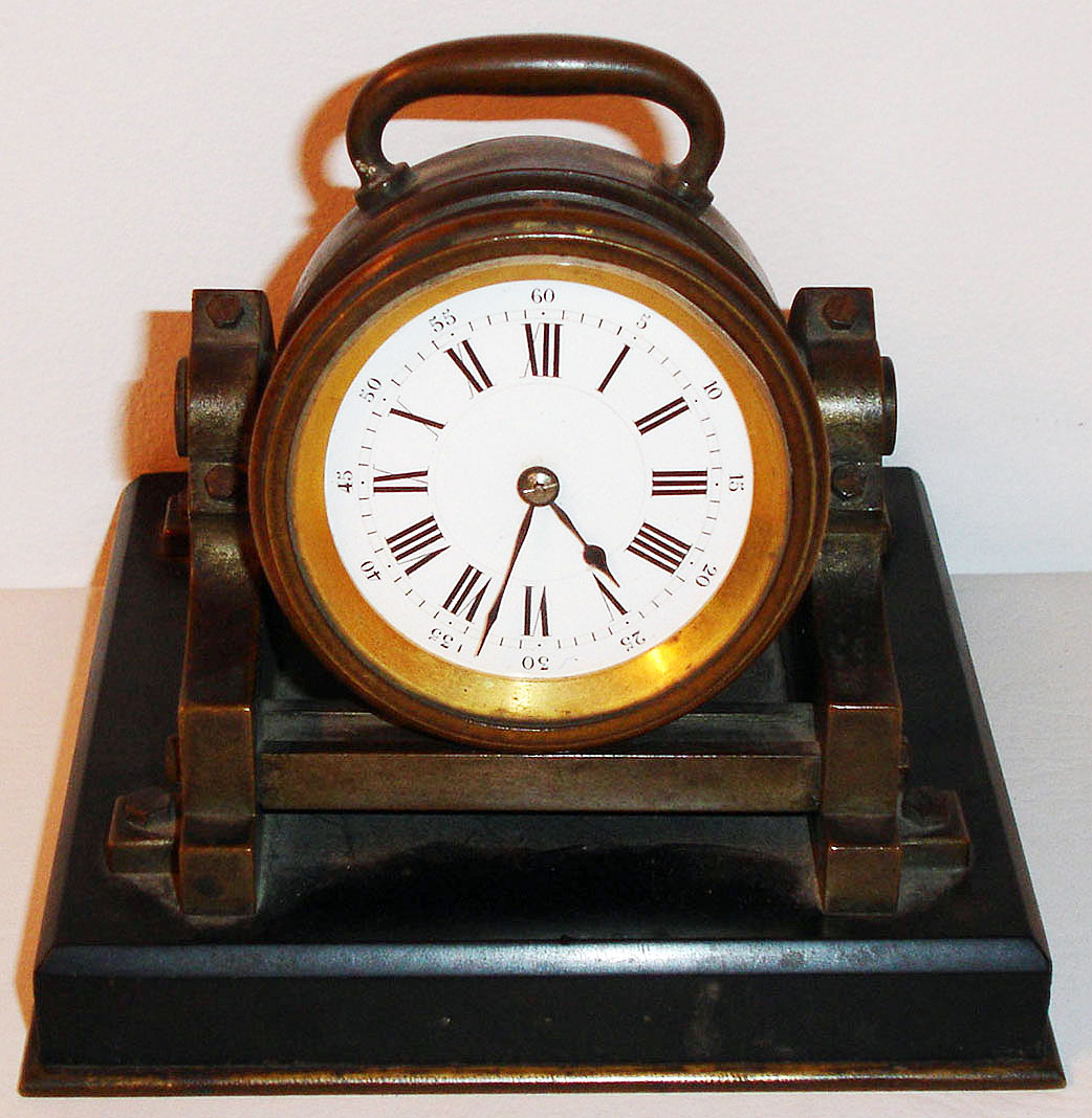 France, bronze cannon form desk clock mounted on a black slate base with brass trim, eight day time only movement with cylinder platform white enamel Roman numeral dial with Arabic five minute markers, blued steel hands, c1890 — Antique Clocks Price Guide