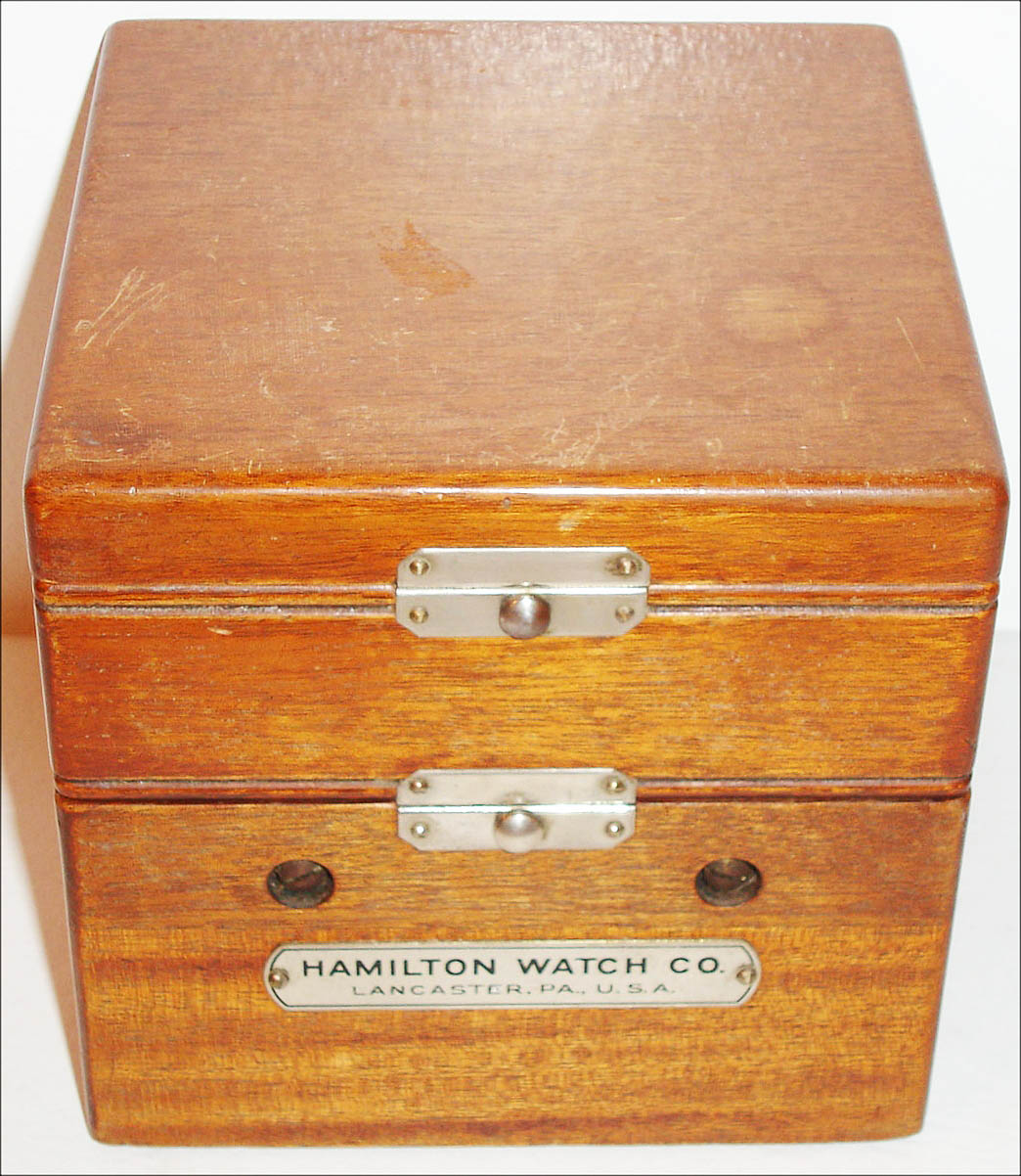 Hamilton Watch Co., Lancaster, Penn., model 22 deck watch, 35 size, 21 jewel, two day movement with cotes de Geneve decoration, matte silver Arabic numeral dial signed Hamilton Lancaster Pa., U.S.A., blued steel hands, plastic crystal, mahogany box with gimbals and locking lever, plate on front of box marked Hamilton Watch Co., Lancaster Pa., U.S.A, c1950 — Antique Clocks Price Guide