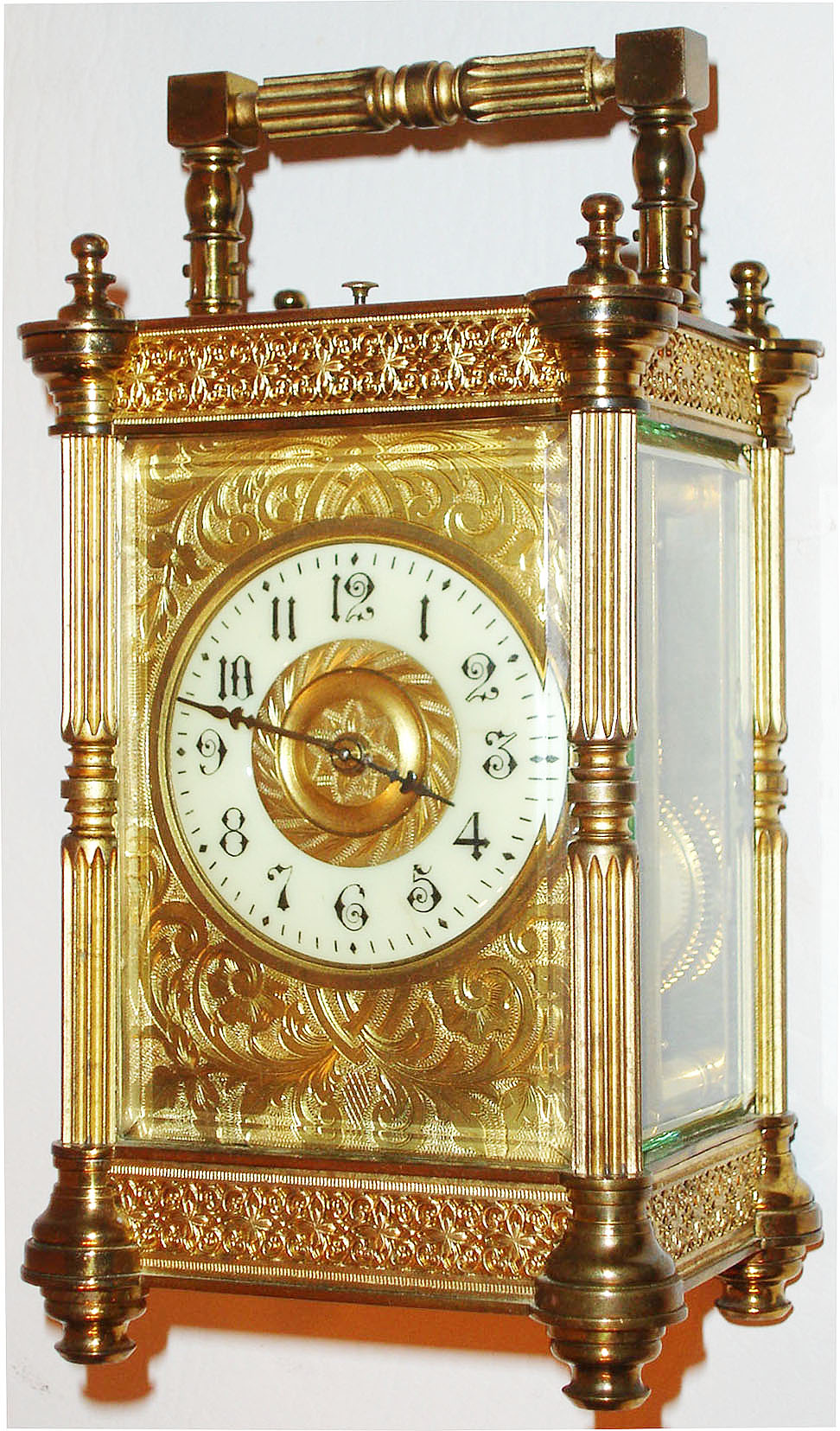 France, eight day time, strike and hour repeating carriage clock, lever platform, white enamel Arabic numeral dial, blued steel hands, gilt dial mask and center with acanthus leaf engraving, polished pillars style case with turned feet and finials, with a matte gilt blind fret at the case top and bottom, and beveled glass panels c1900 — Antique Clocks Price Guide