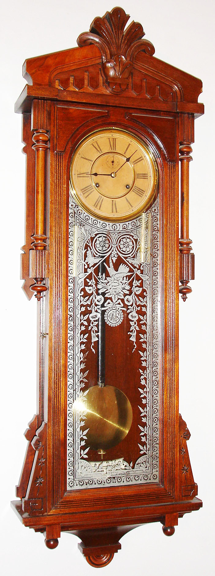 Ansonia Clock Co., New York, NY, "Bagdad" wall clock, 8 day, time only, two weight driven movement in a mahogany case with silk screened pattern and Ansonia logo and paper dial, c1904 — Antique Clocks Price Guide