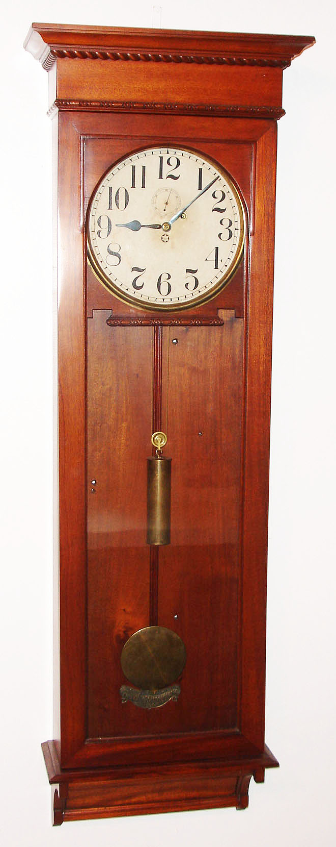 New Haven Clock Co., New Haven, Conn., "Stanton" wall regulator clock, 8 day, time only, weight driven movement with maintaining power in a mahogany case with paper dial, brass weight, beat indicator and pendulum bob, c1911 — Antique Clocks Price Guide