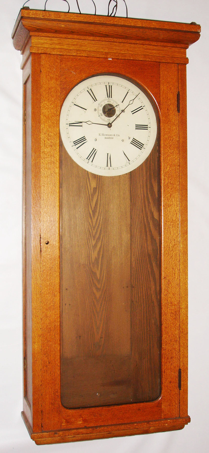 E. Howard and Co., Boston, Mass., "Regulator No. 89" wall clock, time only, self-winding movement in an oak case with painted metal dial, c1913 — Antique Clocks Price Guide