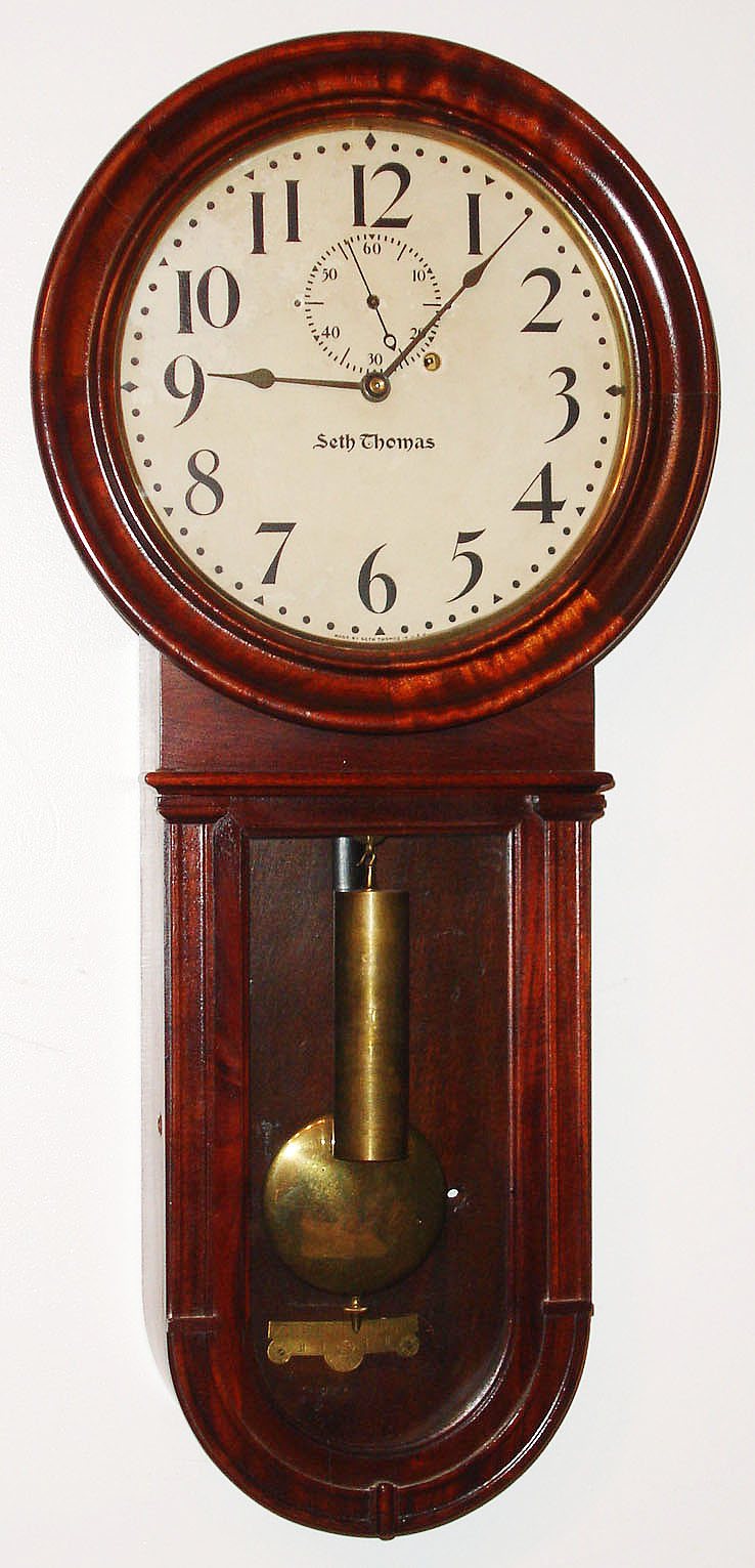 Seth Thomas Clock Co., Thomaston, Conn., "Regulator No. 1 Keyhole" wall clock, 8 day, time only, weight driven movement in a mahogany case with painted metal dial, c1915 — Antique Clocks Price Guide