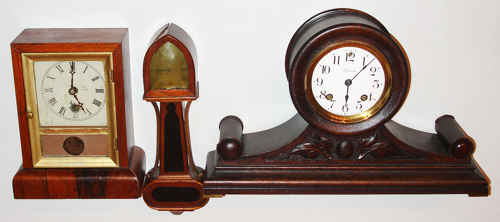 Clocks- 3 (Three)- Mixed lot consisting of a small Gilbert cottage clock and a miniature New Haven banjo timepiece and an Ansonia Clock Co., New York, NY, "Cabinet No. 31", 8 day, time and strike Tambour style mantel clock, c1914 — Antique Clocks Price Guide