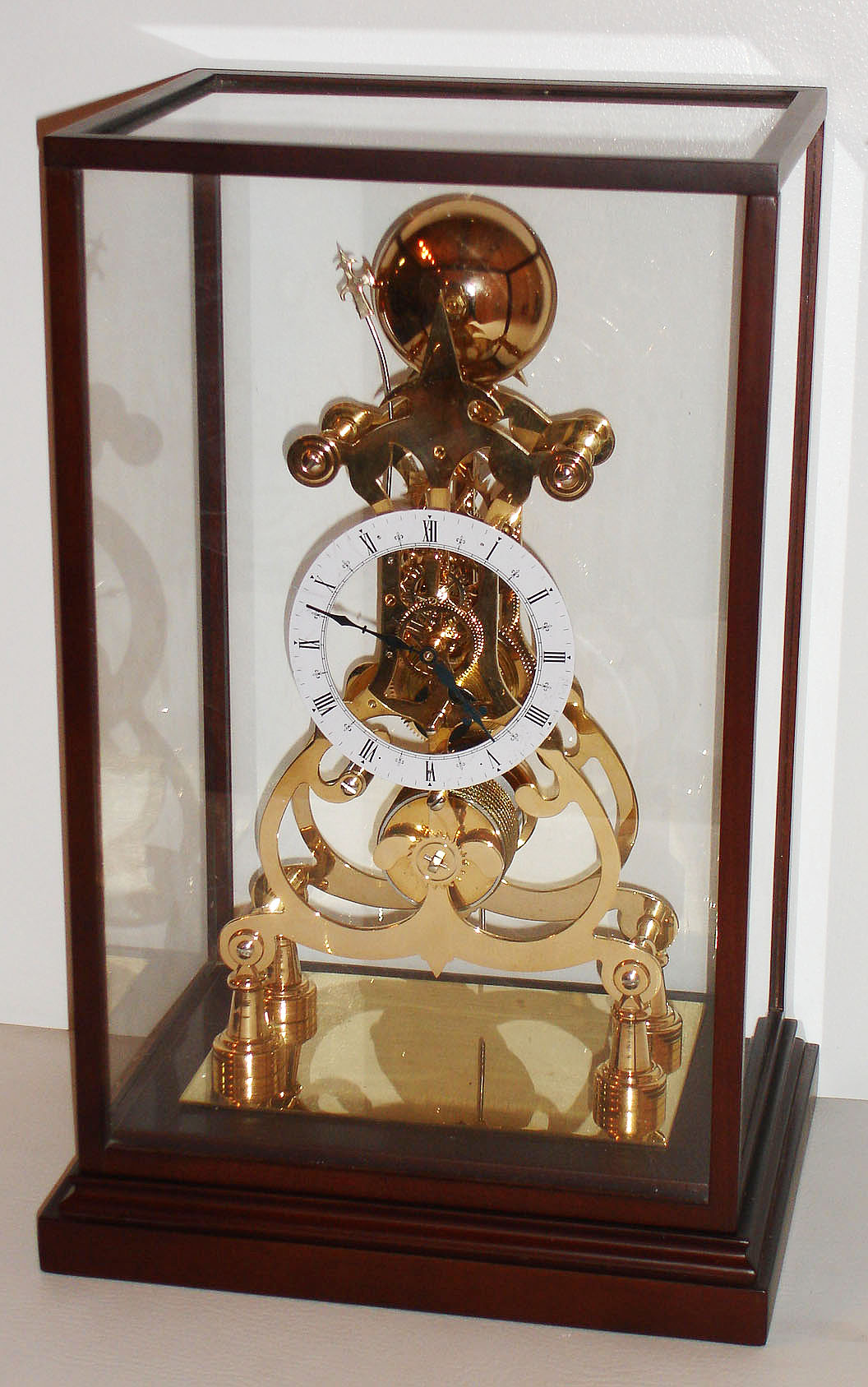 Skeleton clock, Chinese reproduction, 8 day fusee with passing strike, lacquered brass in wood and glass case, contemporary — Antique Clocks Price Guide