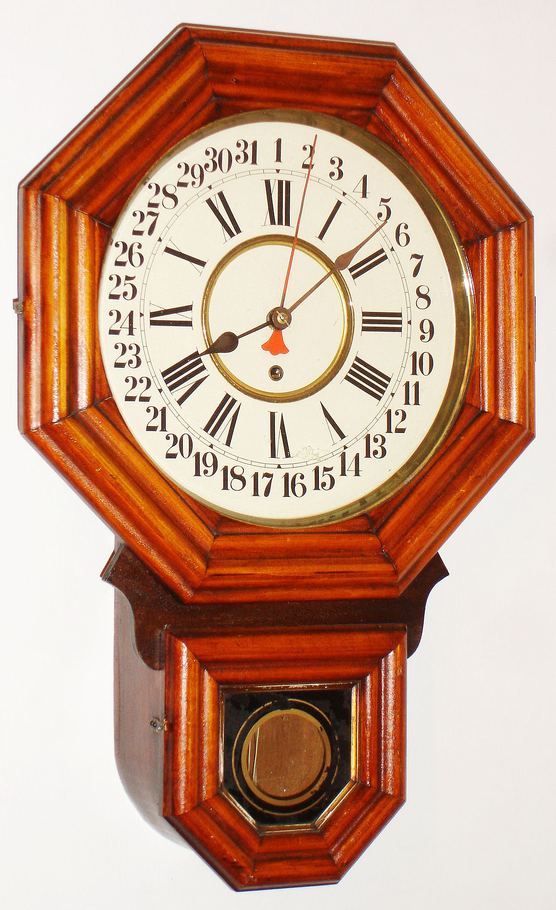 E. Ingraham, Bristol, Conn., "12 Inch Ingot" grained wood 8 day time and calendar wall clock, c1910 — Antique Clocks Price Guide