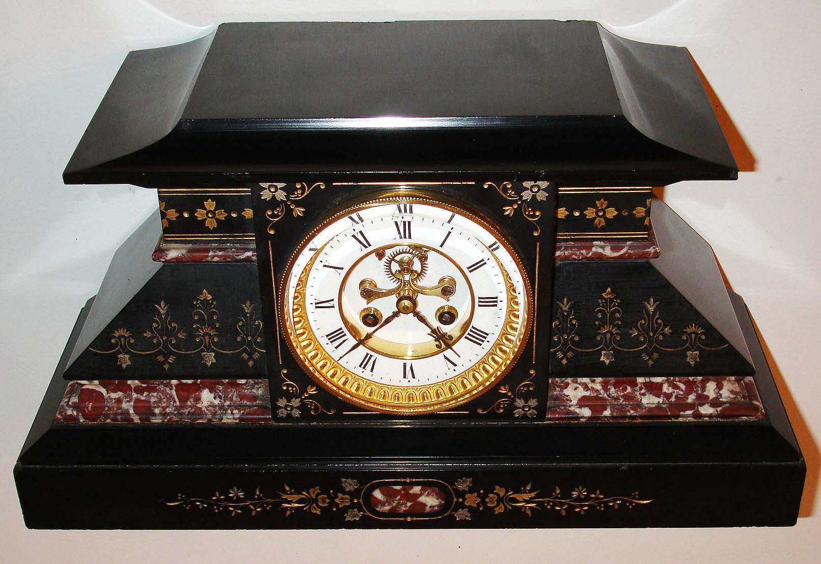 France, Belgian slate mantel clock with red and white marble moldings, gilt incised line and leaf decoration, white enamel Roman numeral dial with blued steel hands, gilt bezel with thick beveled glass, 8 day pendule a Paris time and strike movement signed Marti with Brocot open escapement, c1880 — Antique Clocks Price Guide