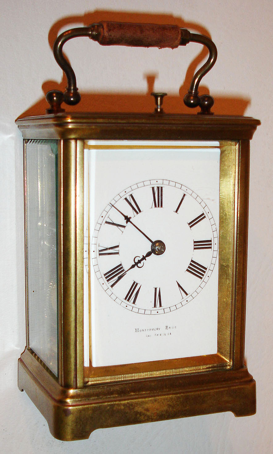 France, for Montgomery Bros., Los Angeles, 8 day petit sonnerie carriage clock with repeating on gongs, two train time and strike movement with lever platform, white enamel Roman numeral dial, blued steel hands, Corniche style case with beveled glasses, with outer leather covered travelling case and key, c1910 — Antique Clocks Price Guide