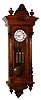 Wilhelm Kunz, Wien, Austria "Vienna Regulator in Altdeutsch Style" wall clock, 8 day, time and Grande Sonnerie strike, three weight driven movement in a walnut case flanked by fluted fully turned columns with elaborately carved capitals and bases and two part white enamel dial, c1880