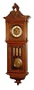 Gustav Becker, Freiburg, Germany, "Vienna Regulator in Baroque Style" wall clock, 8 day, time and Grande Sonnerie strike, three embossed weight driven movement with embossed pendulum bob in a walnut case with carved top and other applied carvings.  The multicolor and white enamel dial is inset with embossed brass center, c1880