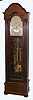 Herschede Clock Co., Cincinnati, Ohio, "Pattern No. 310", 5 tube hall clock, 8 day, time, strike and chime, three weight driven movement playing Westminster tune in a mahogany case with reeded full columns on sides, bun feet and three glass trunk. The silvered dial has applied brass Arabic numerals, and engraving, c1920