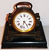 France, bronze cannon form desk clock mounted on a black slate base with brass trim, eight day time only movement with cylinder platform white enamel Roman numeral dial with Arabic five minute markers, blued steel hands, c1890