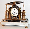 France, small industrial beam engine desk clock by Guilmet, eight day time only movement, back plate marked Medialle D'Or GLT Paris, white enamel Roman numeral dial with blued steel Breguet style hands, the engine with bright and patinated silver and gold surfaces, mounted on a white marble base with turned brass feet, c1880