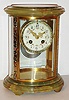 France, 8 day, time and strike, crystal regulator in oval case, Japy Freres movement striking the hours and half hours on a gong, white enamel Arabic numeral dial decorated with floral swags, fancy gilt hands, champleve enamel bezel, case top and bottom of green onyx, with champleve enamel frame, beveled glass panels, c1900