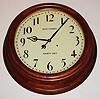 Seth Thomas Clock Co., Thomaston, Conn., "Gallery 18 Inch" wall clock, 30 day, time only, double spring driven movement in a mahogany case with painted metal dial, c1913