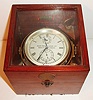 Henry Browne and Sons Ltd., Barking, London, marine chronometer in mahogany box, the 2 day movement with spring detent escapement, cut bimetallic balance with cylindrical weights for temperature compensation, white helical balance spring, spotted gilt plates with blued steel screws, silvered Roman numeral dial with wind indicator and number 16926, blued steel hands, brass bezel with beveled glass, lacquered brass bowl and hardware, mahogany box with glazed top, brass tag showing chronometer number, with key c1910
