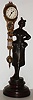 Reproduction miniature 30 hour swinger with bronzed figure on turned wood base, contemporary